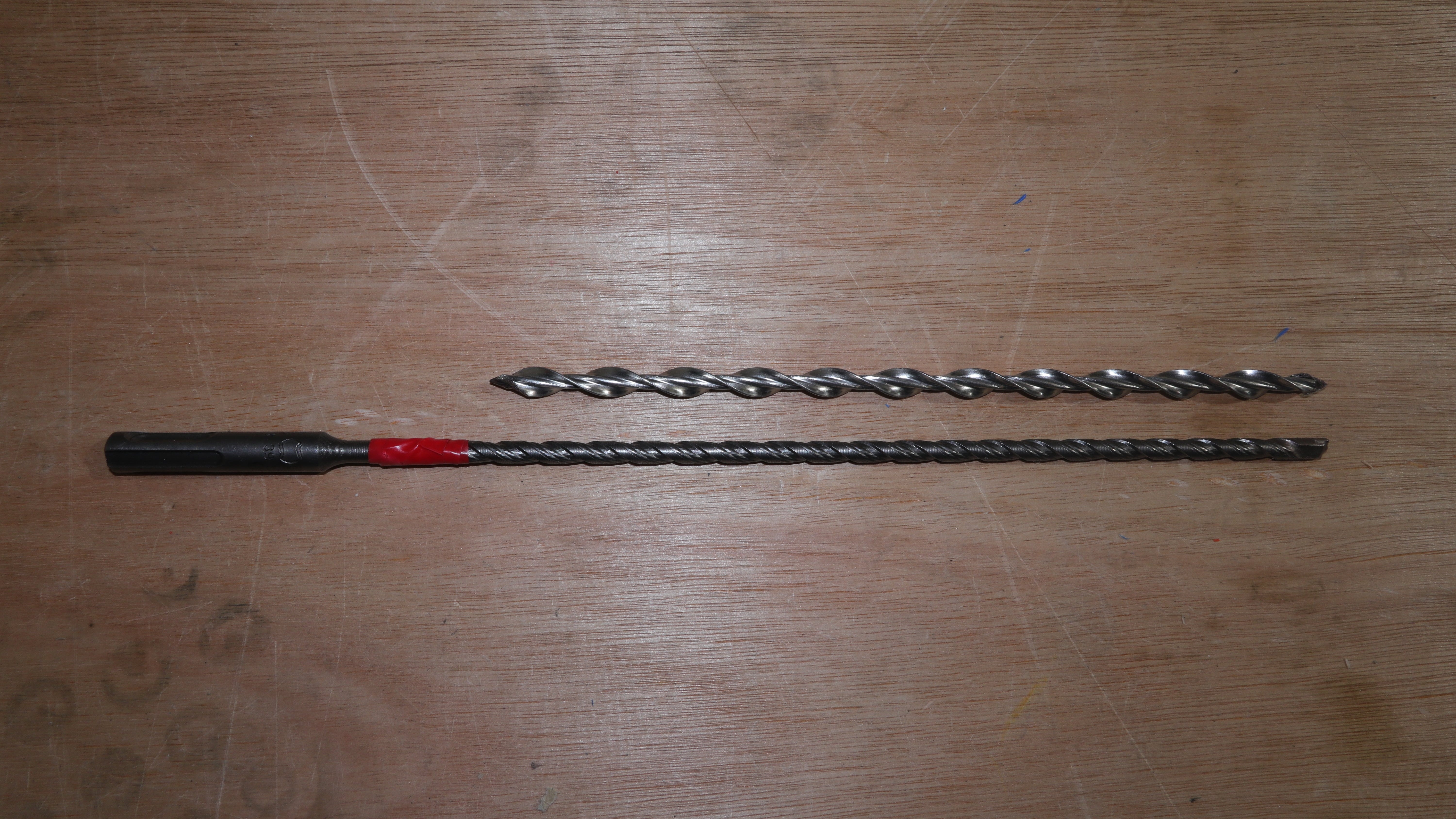 A drill bit next to a remedial wall tie ready for wall tie installation 
